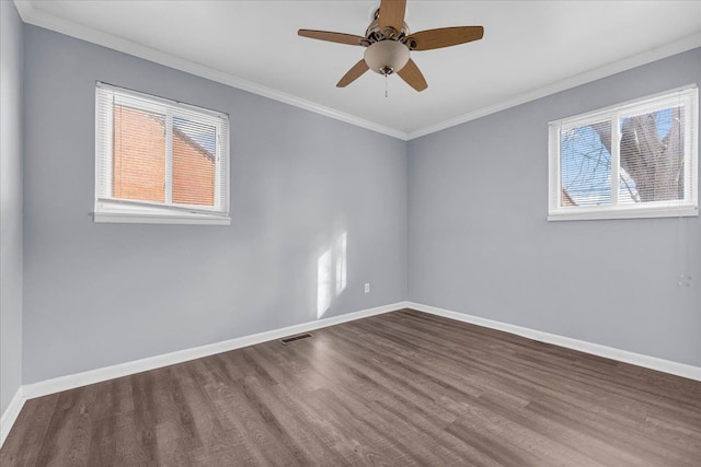 empty room featuring crown molding, wood-type flooring, and ceiling fan