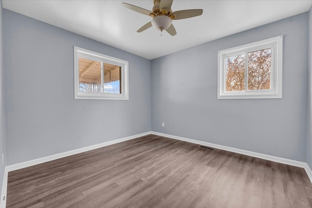 unfurnished room with hardwood / wood-style floors and ceiling fan