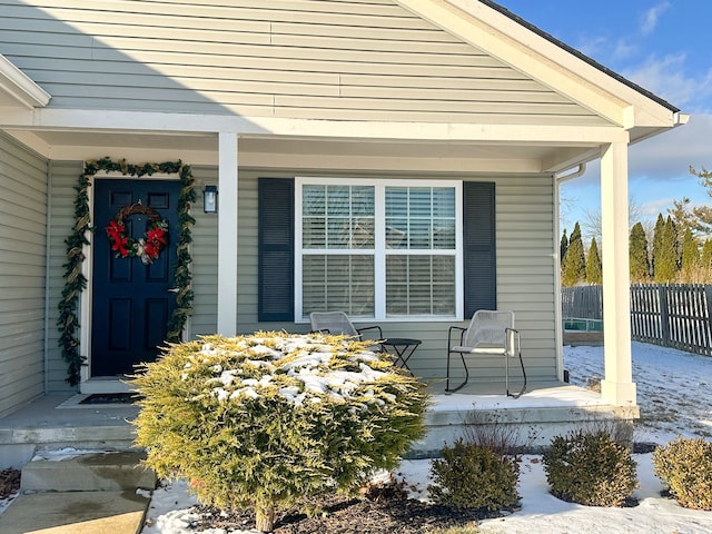 view of exterior entry with covered porch