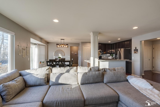 living room featuring hardwood / wood-style floors and ornate columns