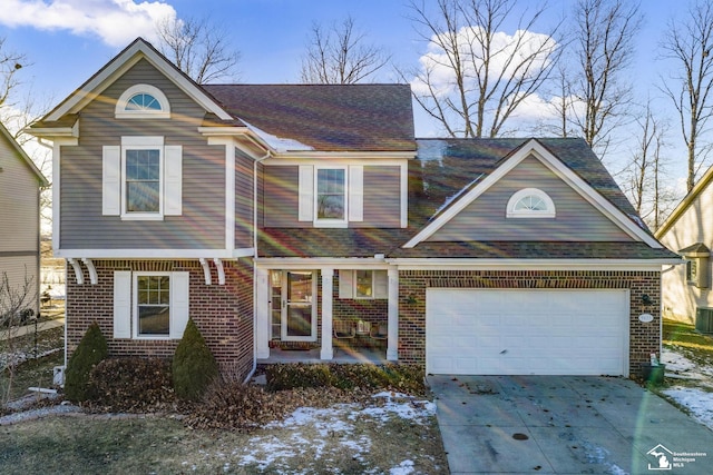 view of front of home with central AC and a garage