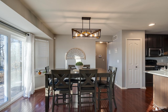 dining room with dark hardwood / wood-style flooring