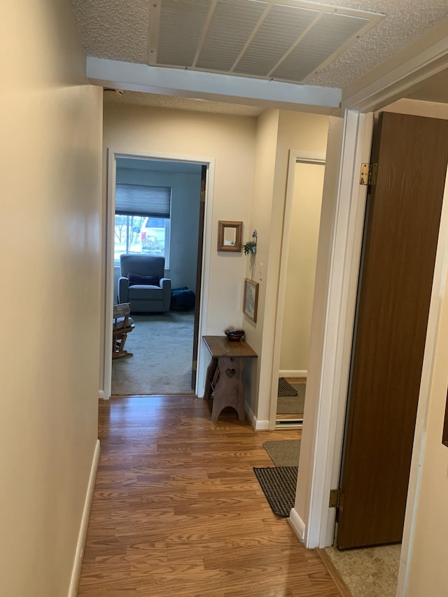 hallway with hardwood / wood-style flooring