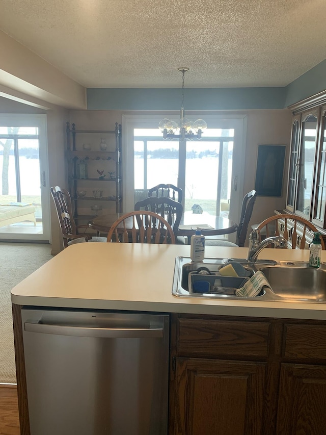 kitchen featuring sink, stainless steel dishwasher, a chandelier, and a textured ceiling