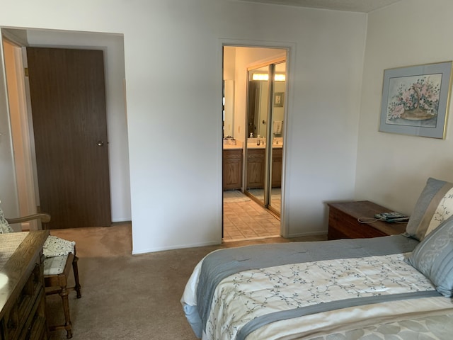 carpeted bedroom featuring ensuite bathroom