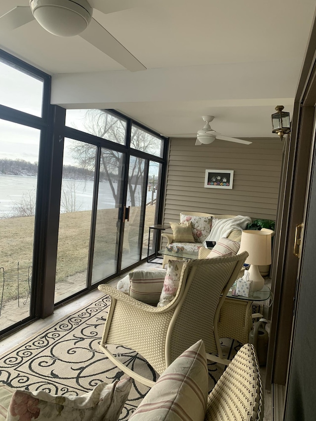 sunroom featuring ceiling fan