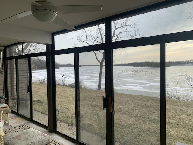 interior space featuring a water view and a wall of windows