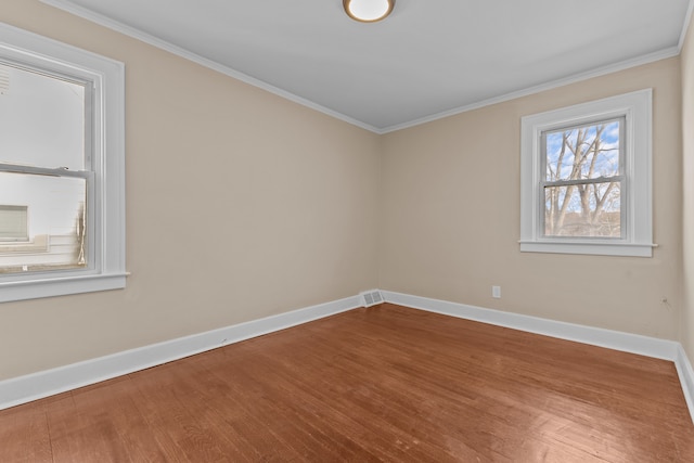 unfurnished room with hardwood / wood-style floors and crown molding