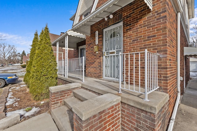 view of exterior entry featuring covered porch