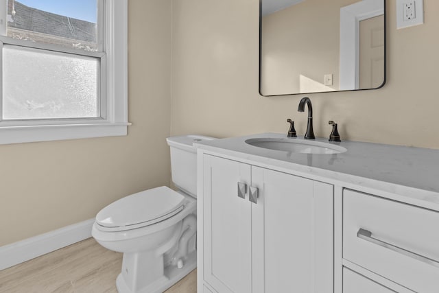 bathroom with vanity, wood-type flooring, and toilet