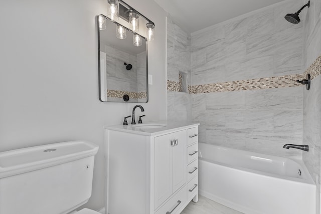 full bathroom with tiled shower / bath, vanity, and toilet