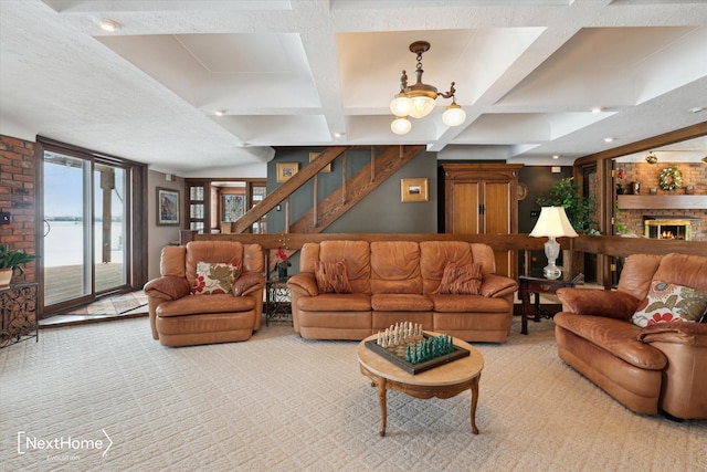 living room featuring beam ceiling, coffered ceiling, a fireplace, a textured ceiling, and light colored carpet