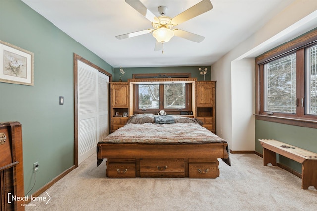 carpeted bedroom featuring a closet and ceiling fan