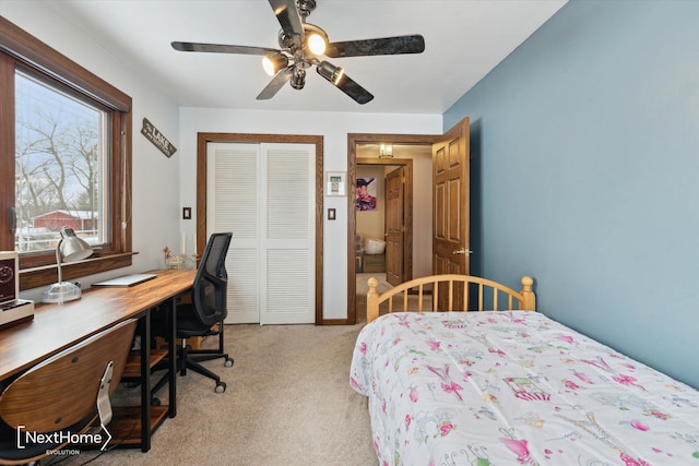 bedroom featuring light carpet, ceiling fan, and a closet