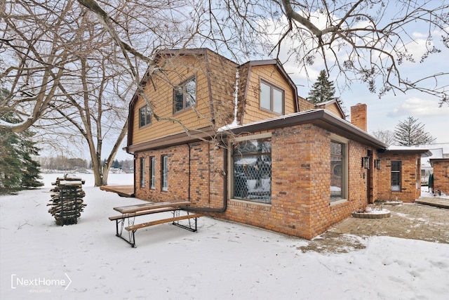 view of snow covered rear of property