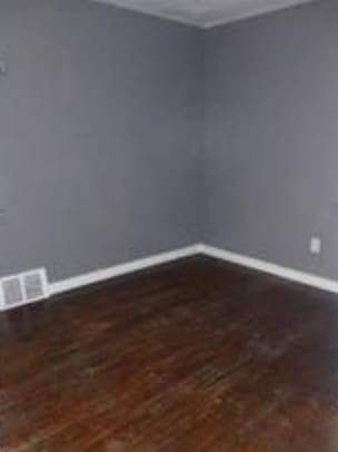 spare room with dark wood-type flooring