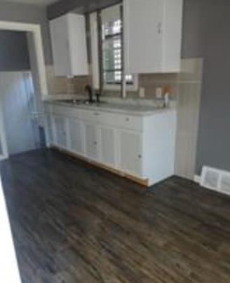 kitchen featuring dark hardwood / wood-style floors, sink, and white cabinets