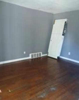 empty room featuring dark hardwood / wood-style flooring