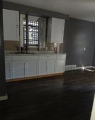 kitchen featuring a mail area, sink, and white cabinets