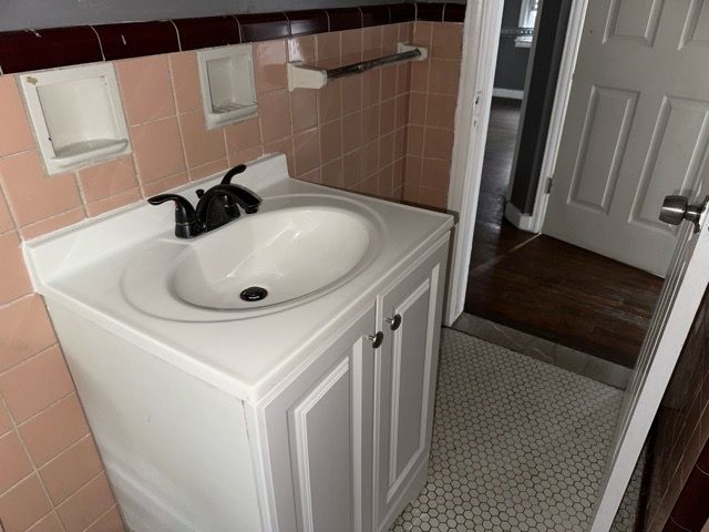 bathroom featuring vanity, tile walls, and tile patterned floors