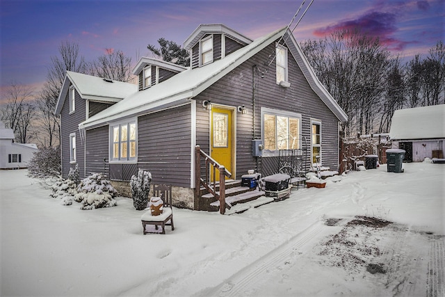 view of snow covered back of property