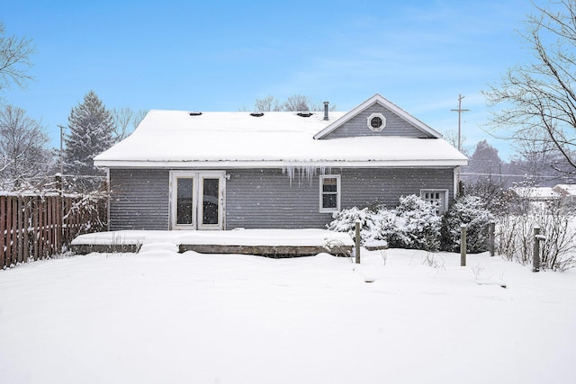 view of snow covered back of property