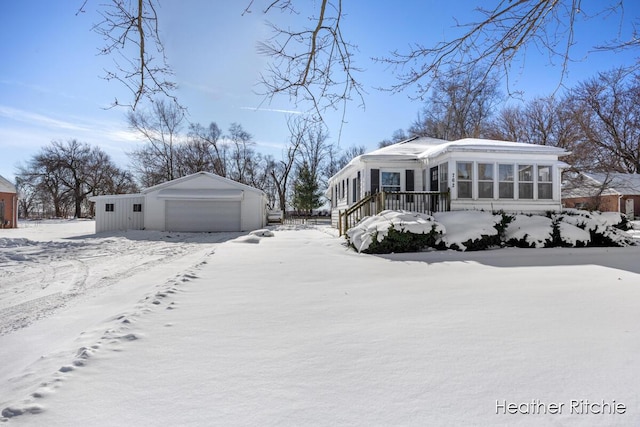 exterior space featuring a garage and a sunroom