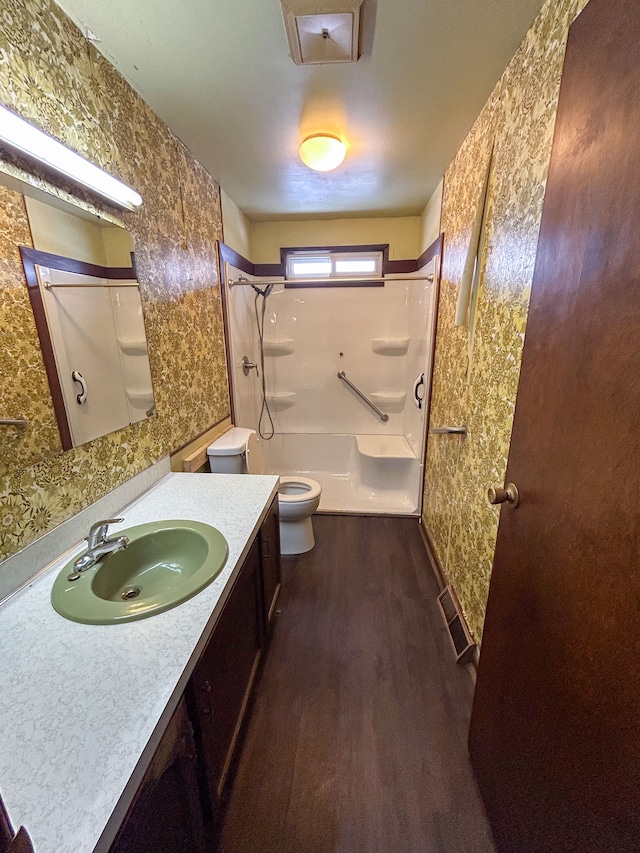 bathroom with vanity, toilet, and hardwood / wood-style floors