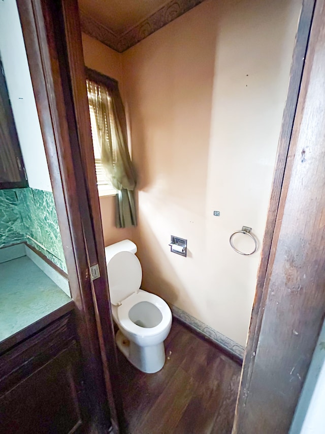 bathroom with hardwood / wood-style flooring and toilet