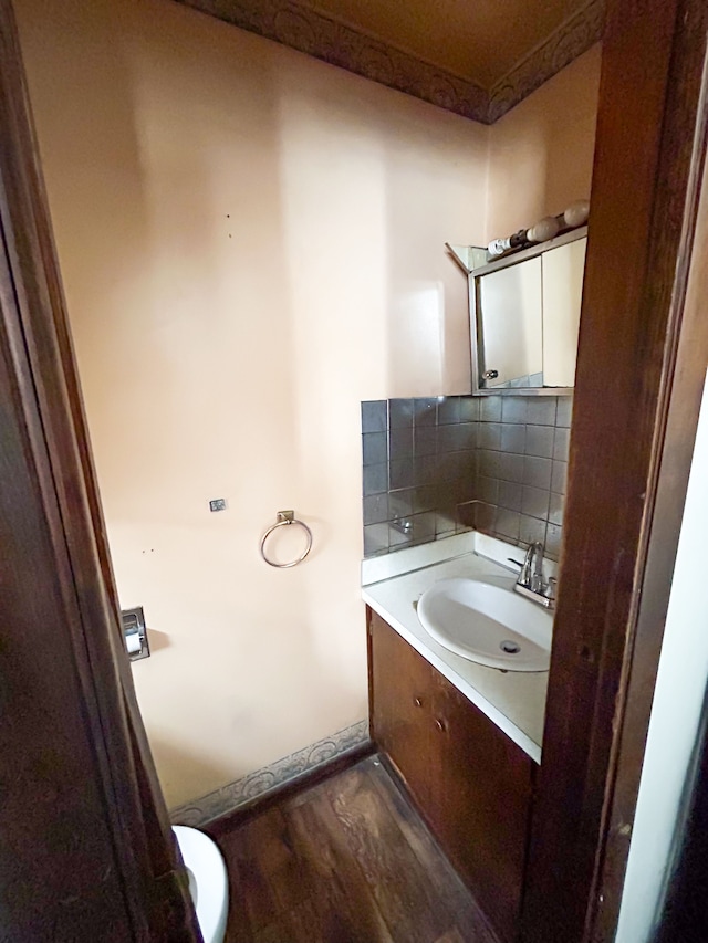 bathroom with vanity, decorative backsplash, and hardwood / wood-style flooring