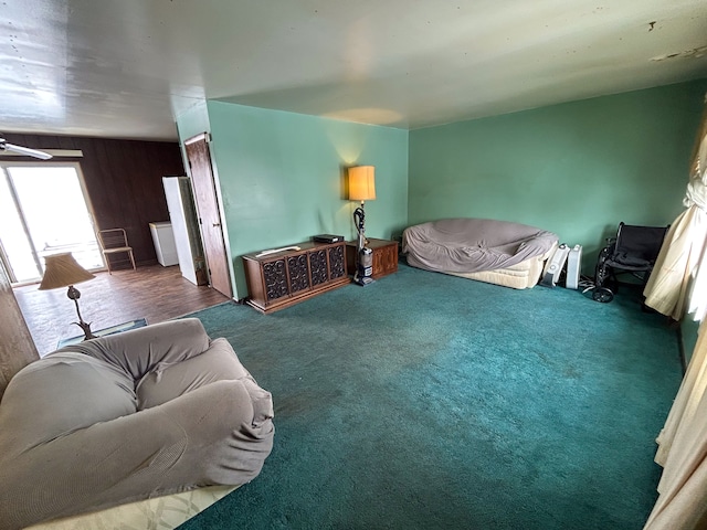 living room with dark colored carpet