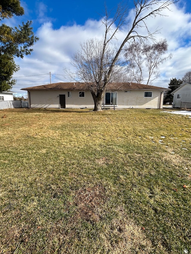 rear view of house with a lawn