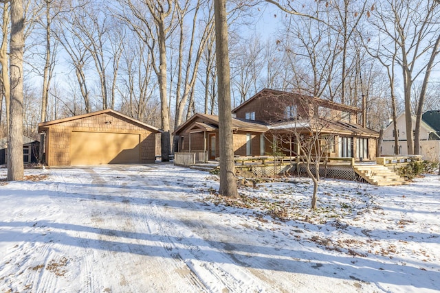 view of front of home with a garage, an outdoor structure, and covered porch