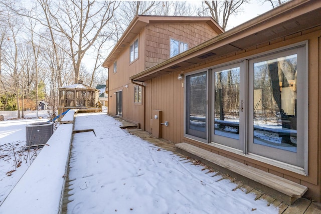 view of snowy exterior with central AC unit