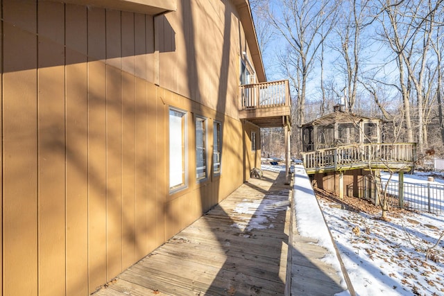 snow covered property featuring a deck