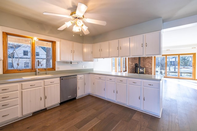 kitchen with sink, white cabinetry, dark hardwood / wood-style flooring, dishwasher, and kitchen peninsula