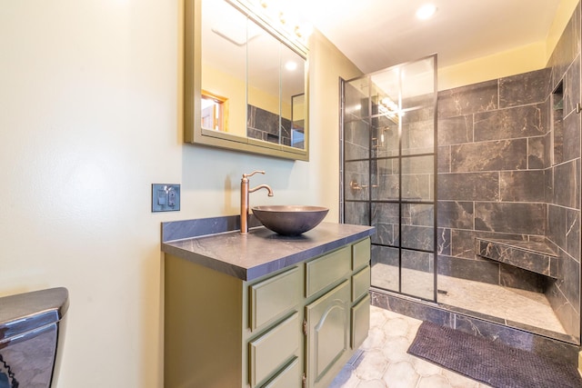 bathroom with vanity, tiled shower, and toilet