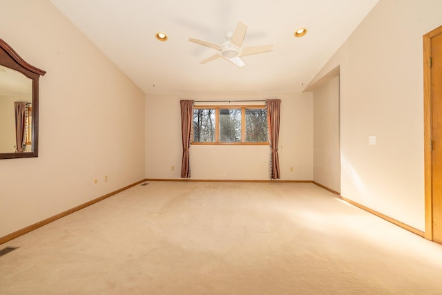 empty room featuring ceiling fan, lofted ceiling, and carpet floors