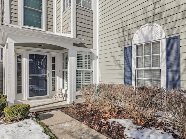 view of snow covered property entrance