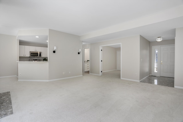 unfurnished living room with light colored carpet