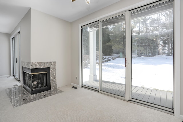 unfurnished living room with light carpet and a multi sided fireplace