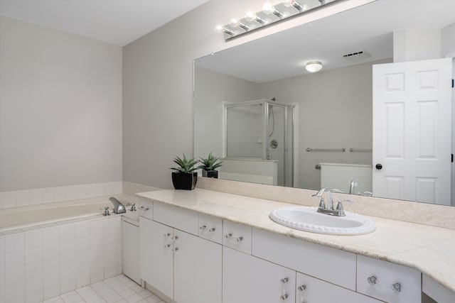 bathroom featuring vanity, tile patterned floors, and separate shower and tub