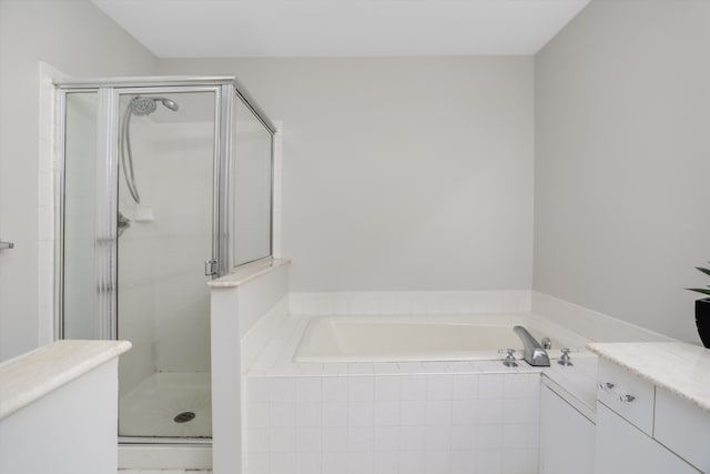 bathroom featuring separate shower and tub