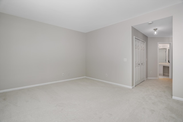 spare room with light colored carpet