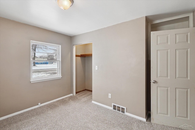 unfurnished bedroom featuring carpet flooring and a closet