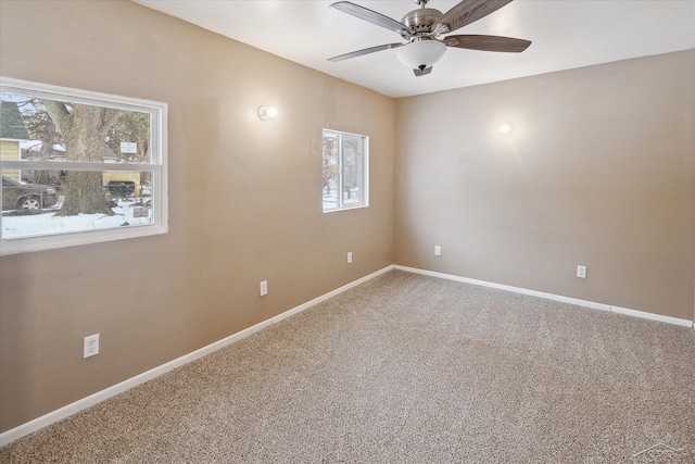 unfurnished room featuring ceiling fan, a healthy amount of sunlight, and carpet floors