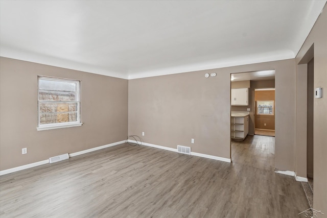 empty room with hardwood / wood-style floors