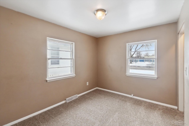 spare room featuring carpet flooring