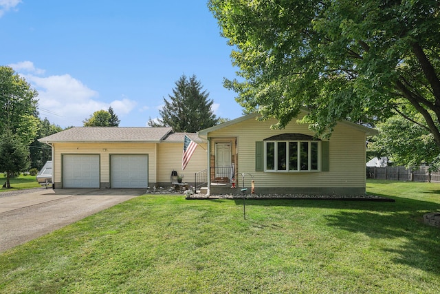 single story home featuring a garage and a front lawn