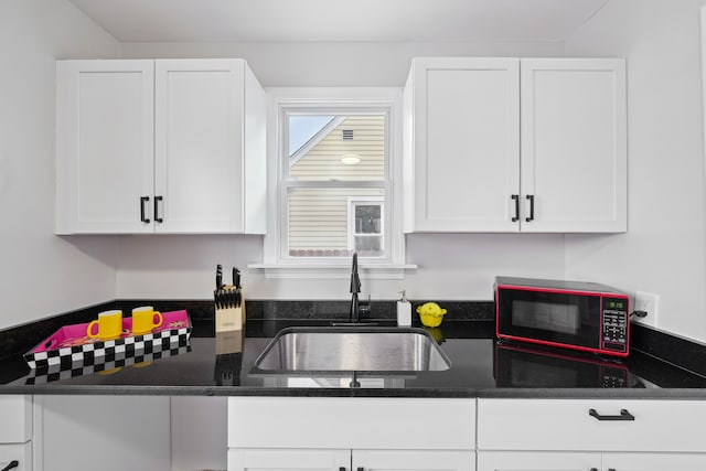 kitchen with white cabinetry and sink